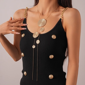 Detail of a layered long gold necklace with spiral textured round metal discs