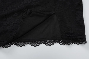 Macro detail of black lace trim and opaque inner lining of a summer V-neck dress