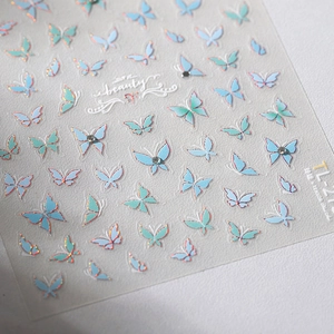 Minimalist butterfly nail stickers with blue-green wings, rose gold edges and rhinestones