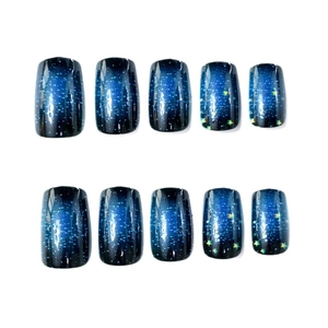 Starry sky press-on nails with blue gradient finish and yellow star patterns