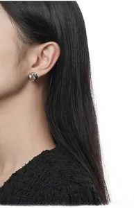 Close-up of irregular liquid metal S925 sterling silver stud earring on model ear