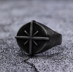 Macro shot of vintage compass star engraving on distressed silver punk ring