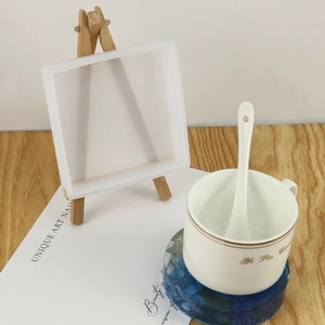 Close-up of square silicone coaster mold on a wooden stand for DIY resin casting art