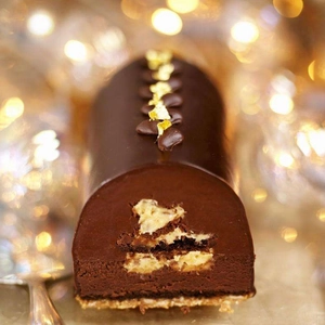 Chocolate mousse cake with edible gold foil flakes and coffee bean topping decor