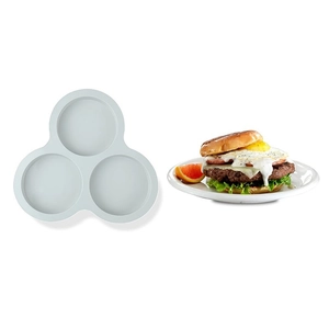 Three-cavity white silicone burger mold shown next to a finished egg hamburger