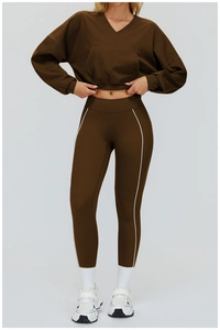 Detail view of coffee athletic set with V-neck hoodie and white striped leggings