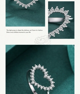 Macro detail of S925 silver heart ring showing pavé-set zircons on green velvet