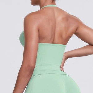 Back view of mint green high-impact halter sports bra and high-waist seamless leggings set