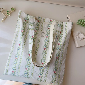 Floral print cotton tote bag with green vine patterns and sturdy shoulder handles
