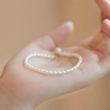 Close-up macro of natural baroque freshwater pearl bracelet held in hand with soft luster