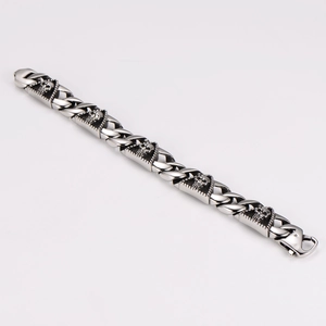 Detail of vintage silver punk bracelet with skull and triangle links and lobster clasp