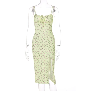 Detail of light green floral dress showing bust ruching, tie-knot, and side slit