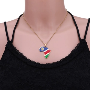 Detail of gold Namibia map pendant with colorful flag enamel on a fine chain necklace