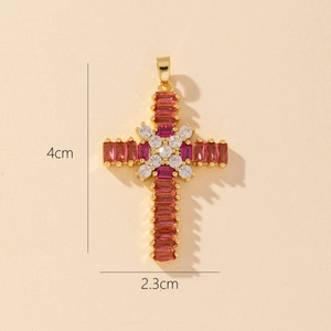 Detailed close-up of gold cross pendant with red and clear gemstones and size dimensions