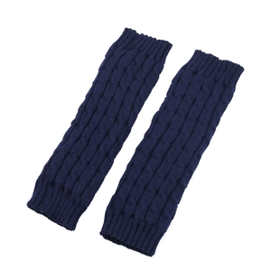 Detail view of navy blue cable knit leg warmers with ribbed cuffs on white background