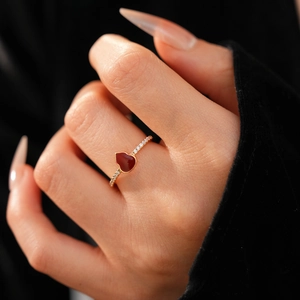 Close-up of 18k gold plated ring with a red heart-shaped stone and micro-pave zircons