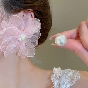 Detailed view of pink chiffon flower earrings with a large white pearl center