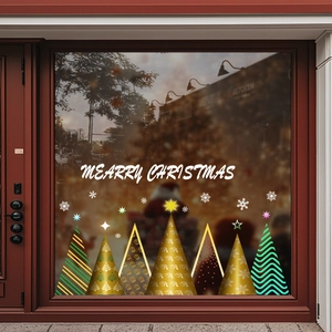Golden Christmas tree stickers with Merry Christmas lettering on a glass window
