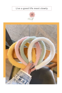 Close-up of plush velvet headbands in pink, yellow, mint green and white soft colors