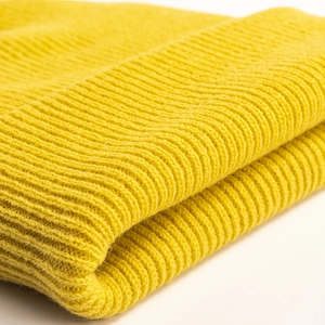 Close-up of bright yellow ribbed knit beanie showing soft wool texture and elastic weave