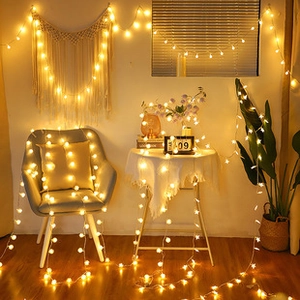 Star-shaped LED string lights with warm glow decorating a cozy indoor living room space