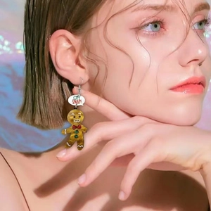 Chic gingerbread man earrings with Oh Snap text displayed on a model for Christmas