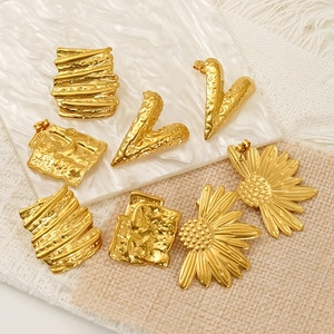Irregular gold flower earrings in stainless steel with textured geometric designs
