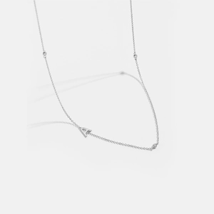 Detailed view of silver letter A pendant necklace with sparkling accents on fine chain