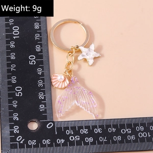 Fashion keychain with starfish shell and mermaid tail charm including size and 9g weight