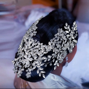 Detailed close-up of bridal headband with silver wire flowers and crystal rhinestones