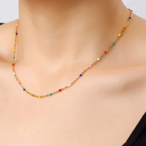 Colorful beaded bohemian necklace with a gold stainless steel chain on a model