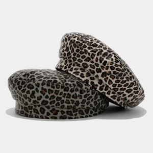 Detailed view of leopard print PU leather beret hats showing texture and stitching