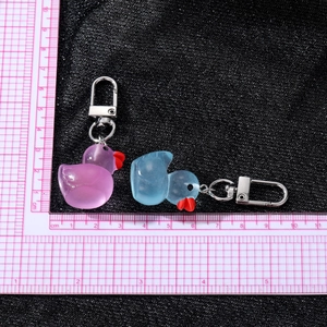 Cute translucent resin duck keychains in purple and blue with silver metal clips