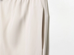 Close-up of side pocket detail on cream puff sleeve shirt trousers set in twill fabric