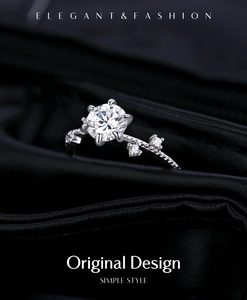 Detail of a 1-carat moissanite ring with six-prong setting and vine-style band