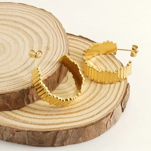18K gold plated stainless steel hoop earrings with wavy texture on wooden slices