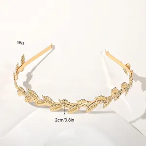 Macro detail of golden metal leaf headband showing 2cm width and engraved texture