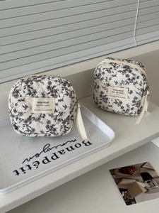 Quilted cotton storage pouches featuring black and white floral patterns and zipper closure