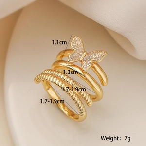 Detail of layered gold-plated butterfly ring with zirconia stones and spiral texture