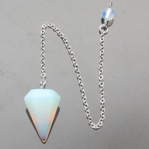 Macro shot of hexagonal opalite energy pendulum with a fine silver chain and metal bead