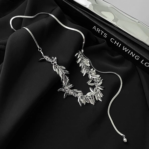 Silver wheat spike tassel necklace with sleek snake chain on premium black background