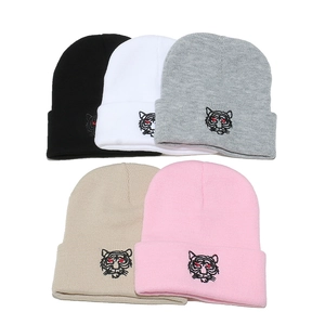 Winter knitted beanie hats with tiger head embroidery in black, white, gray, and pink