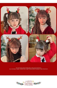 Close-up of girls wearing Christmas reindeer antler hair clips with colorful pompoms