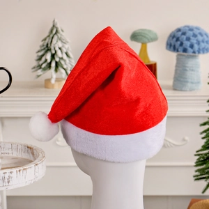 Classic red plush Christmas hat with white fur trim on a model head in festive home setting