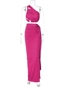 Detail of rose red two-piece set featuring ruched crop top and high slit maxi skirt texture