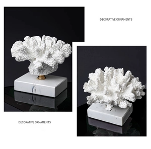 Dettaglio di corallo bianco decorativo con inserto dorato e base in marmo