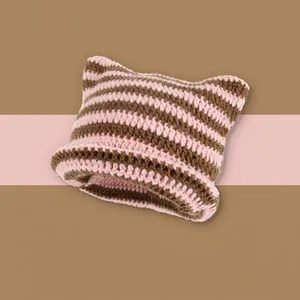 Detail of pink and brown striped knit beanie with cat ear design and rolled edge