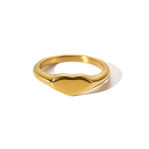 Macro view of minimalist 18K gold plated heart signet ring with polished finish