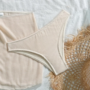 Macro detail of creamy waffle texture fabric for women's three-piece beach bikini set