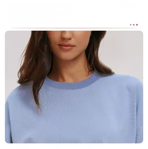 Close-up of the ribbed crew neck design on a comfortable light blue athletic sweatshirt